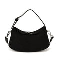 Black handbag with chain straps on a white background